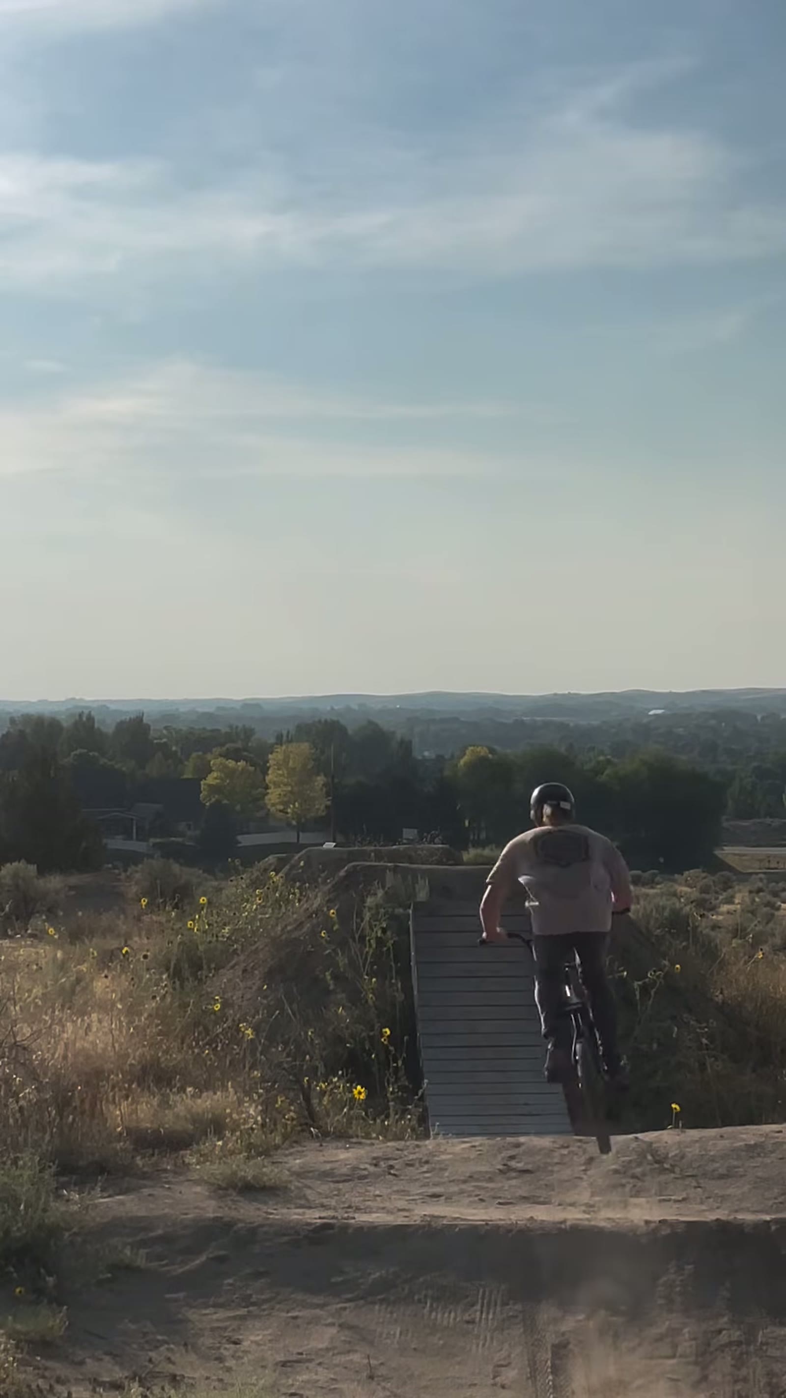 Melville Smith mid-air over a dirt jump line at Eagle Bike Park, Boise
